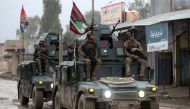 Iraqi pro-government forces patrol the eastern part of the embattled Iraqi city of Mosul on December 28, 2016, during an ongoing military operation against Islamic State (IS) group jihadists. / AFP.