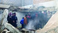 People watch rescue operations after a car bombing attack at the opposition controlled Soran district of Aleppo, yesterday. 