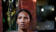 Jona speaks to reporters at the entrance of her house near the coffin of her son Jonel Segovia, who was shot dead by suspected vigilantes at a house storing illegal narcotics, police said on Thursday, in Caloocan city, Metro Manila, in the Philippines Dec