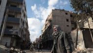 Syrian Abu Khaled looks at the rubble of his destroyed house in the rebel-held town of Douma, on the eastern outskirts of Damascus, on December 30, 2016, on the first day of a nationwide truce. AFP / Abd Doumany
