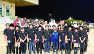 Young riders pose for a picture with Qatar Equestrian Federation (QEF) officials during the Al Rayyan International Show Jumping Championship at QEF's Main Arena.