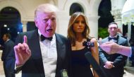US President-elect Donald Trump, accompanied by wife Melania, answers questions from reporters at a New Year party at Mar-a-Lago in Palm Beach.
