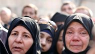 Women react outside a government military police centre to visit their relatives who were evacuated from the east Aleppo and are being prepared for military service in Aleppo, December 11, 2016 (REUTERS) 