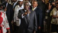 (FILES) This file photo taken on October 15, 2014 shows Afonso Dhlakama, a former Renamo rebel chief turned opposition leader who is seeking the Mozambican presidency for the fifth time, showing his ink-stained finger after casting his ballot at a polling