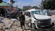 A Somali soldier stands at the scene of a car bomb attack near the Peace Hotel of the capital Mogadishu, on January 2, 2017. Twin suicide car bombs claimed by the Al-Qaeda aligned Shabaab insurgent group wounded nine people today at the entrance to Mogadi