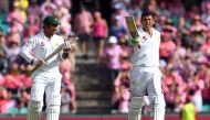Pakistan batsman Younis Khan (R) celebrates scoring his century against Australia as teammate Sarfraz Ahmed (L) applauds during the third day of the third cricket Test match at the SCG in Sydney on January 5, 2017. (AFP / WILLIAM WEST )