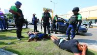 Police detain people for looting while protesting against rising prices of petrol, on the outskirts of Veracruz, Mexico, yesterday.