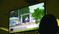 A woman watches on television news about the riot in the PAMC (Agricola de Monte Cristo Penitentiary) in Roraima, northern Brazil, yesterday.