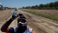 Sam Sunderland of Great Britain throws water on his face after riding his KTM. REUTERS/Ricardo Moraes