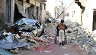 A boy pushes a wheelchair along a damaged street in the east Aleppo neighborhood of al-Mashatiyeh, Syria, in this handout picture provided by UNHCR on January 4, 2017. Bassam Diab
