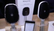 The Kerastase Hair Coach Powered by Withings, the world's first smart hairbrush developed in collaboration with L'Oreal's Research and Innovation Technology Incubator, with accompanying mobile app that helps people better care for their hair, seen during 