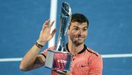 Grigor Dimitrov of Bulgaria lifts his winning trophy after defeating Kei Nishikori of Japan in their men's singles final at the Brisbane International tennis tournament in Brisbane on January 8, 2017.  AFP / SAEED KHAN