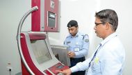 Officials displaying the use of a self-service machine at HIA.