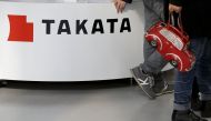 Visitors walk past a logo of Takata Corp on its display at a showroom for vehicles in Tokyo, February 5, 2016 (REUTERS / Toru Hanai) 