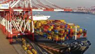 Container boxes are seen loaded in a vessl at a port in China.