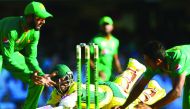 Australian batsman Matthew Wade (centre) dives to make his ground during the one-day international cricket match against Pakistan in Brisbane yesterday. Wade hit a thrilling last-ball century to set up a 92-run victory for Australia.