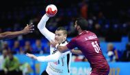 Abdelrahman Abdalla of Qatar and Mohamed Mamdouh Shebib of Egypt vie for ball possession during the 2017 Men's World Championship match of Group D at AccorHotels Arena, Paris, France, yesterday. 