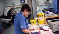 (FILES) This file photo taken on April 2, 2015 shows a member of clinical staff recording details of blood samples in the Accident and Emergency department of the 'Royal Albert Edward Infirmary' in Wigan, north west England. The Red Cross describes a 