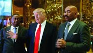 US President-elect Donald Trump speaks to members of media with television personality Steve Harvey (right) and businessman Greg Calhoun after their meeting at Trump Tower in New York, yesterday.