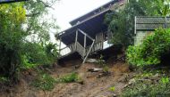 A home sits on the edge of a cliff yesterday after it's concrete portion was washed away in a mudslide caused by heavy rains in Hollywood, California.