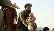FILE PHOTO: An Afghan man holds up the dead body of a child  killed by an air strike called in to protect Afghan and US forces during a raid on suspected Taliban militants in Kunduz, November 3. 2016 (REUTERS / Nasir Wakif) 