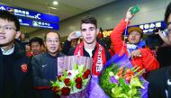 Brazilian international Oscar (centre) is escorted as he arrives at Shanghai airport in China in this January 3 file picture.