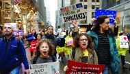 People march towards Trump Tower during a protest organised by the New York Immigration Coalition against President-elect Donald Trump in New York. 