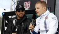 Mercedes F1 driver Lewis Hamilton (L) watches as Williams F1 driver Valtteri Bottas speaks to fans at the Australian Formula One Grand Prix in Melbourne. REUTERS/Brandon Malone/File Photo
