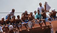 Inmates stand on the prison roof during a rebellion in Alcacuz Penitentiary Center near Natal, Rio Grande do Norte state, northeastern Brazil on January 16, 2017. The latest in a string of brutal prison massacres involving suspected gang members in Brazil