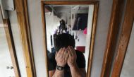 A picture taken in Terespol on December 21, 2016 shows a Chechen man showing scars on his forearms inside a train carriage while returning to the Belarusian city of Brest after a failed attempt to enter Poland. On a snowy day in late December, a commuter 