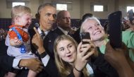 US President Barack Obama holds 10-month-old Brooks Breitwieser as he greets supporters after speaking to a 