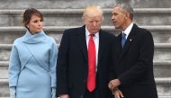 US President Donald Trump speaks to former President Barack Obama as First Lady Melania Trump looks on after inauguration ceremonies at the US Capitol on January 20, 2017 in Washington, DC. / AFP / Robyn BECK