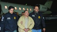Mexico's top drug lord Joaquin “El Chapo” Guzman is escorted as he arrives at Long Island MacArthur airport in New York, yesterday.