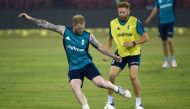 England's Jonny Bairstow (R) and Ben Stokes kick a ball during a training session at the Barabati stadium in Cuttack on January 18, 2017. (AFP / Money SHARMA)