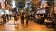 Lebanese security forces secure the street near the cafe in Hamra street in Beirut where a suicide bomber was arrested minutes before exploding himself on January 22, 2017. (AFP).