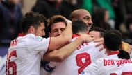 Sevilla's playres celebrate after their team's scoring the third goal during the Spanish league football match CA Osasuna vs Sevilla FC at El Sadar stadium in Pamplona on January 22, 2017. / AFP / ANDER GILLENEA
