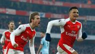 Arsenal's Chilean striker Alexis Sanchez (R) celebrates with Arsenal's Spanish defender Nacho Monreal (2nd L) after scoring their late winner from the penalty spot during the English Premier League football match between Arsenal and Burnley at the Emirate