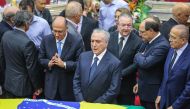 Brazilian President Michel Temer (C) attends the funeral of Supreme Court Justice Teori Zavascki at the Federal Regional Court of the 4th Region, where the wake is being held in Porto Alegre, southern Brazil, on January 21, 2017. Relatives and allies of Z