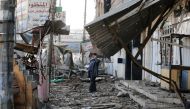 A man speaks on his phone next to destroyed houses at al Zohour area in Mosul, Iraq, January 23, 2017. REUTERS/Muhammad Hamed
