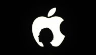 A reporter walk by an Apple logo during a media event in San Francisco California, September 9, 2015 (AFP / Josh Edelson) 