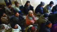 Arrested Indian fishermen sit at a police station in Karachi, yesterday.