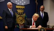 US President Donald Trump signs an executive order he said would impose tighter vetting to prevent foreign terrorists from entering the United States at the Pentagon in Washington, US, January 27, 2017. REUTERS/Carlos Barria