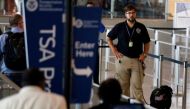 A TSA security officer and his dog scan departing passengers at Lindbergh Field airport in San Diego, California, U.S. July 1, 2016. REUTERS/Mike Blake
