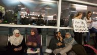 Protesters gather to denounce President Donald Trump's executive order that bans certain immigration, at Dallas-Fort Worth International Airport on January 28, 2017 in Dallas, Texas. President Trump signed the controversial executive order that halted ref