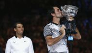 Switzerland's Roger Federer kisses the trophy after winning his Men's singles final match against Spain's Rafael Nadal. (REUTERS/Issei Kato)