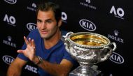 Tennis - Australian Open - Melbourne Park, Melbourne, Australia - early 30/1/17 Switzerland's Roger Federer gestures during a post-match news conference next to his Men's singles final trophy. Reuters/Edgar Su
