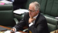 FILE PHOTO - Australia's Prime Minister Malcolm Turnbull looks at his phone during House of Representatives Question Time in Parliament House, Canberra, Australia, November 9, 2016. AAP/Lukas Coch/via REUTERS/File Photo
