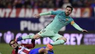 Atletico Madrid's French forward Antoine Griezmann (L) vies with Barcelona's Argentinian forward Lionel Messi during the Spanish Copa del Rey (King's Cup) semi final first leg football match Club Atletico de Madrid vs FC Barcelona at Vicente Calderon stad