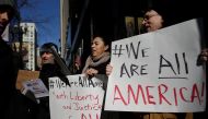 Demonstrators hold up signs during an interfaith solidarity protest against President Donald Trump's executive immigration ban outside the Downtown Islamic Center on February 3, 2017 in Chicago, Illinois. / AFP / Joshua LOTT
