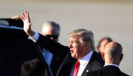 President Donald Trump waves to supporters after arriving on Air Force One at the Palm Beach International Airport for a visit to his Mar-a-Lago Resort for the weekend on February 3, 2017 in Palm Beach, Florida. Joe Raedle/AFP